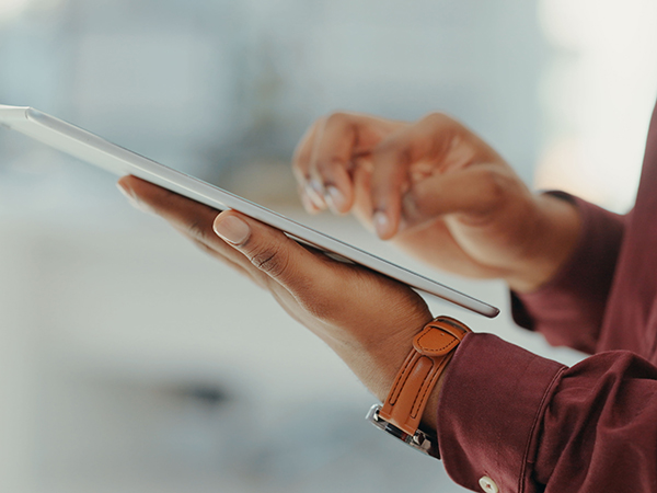 Man using tablet. Closeup of hands.